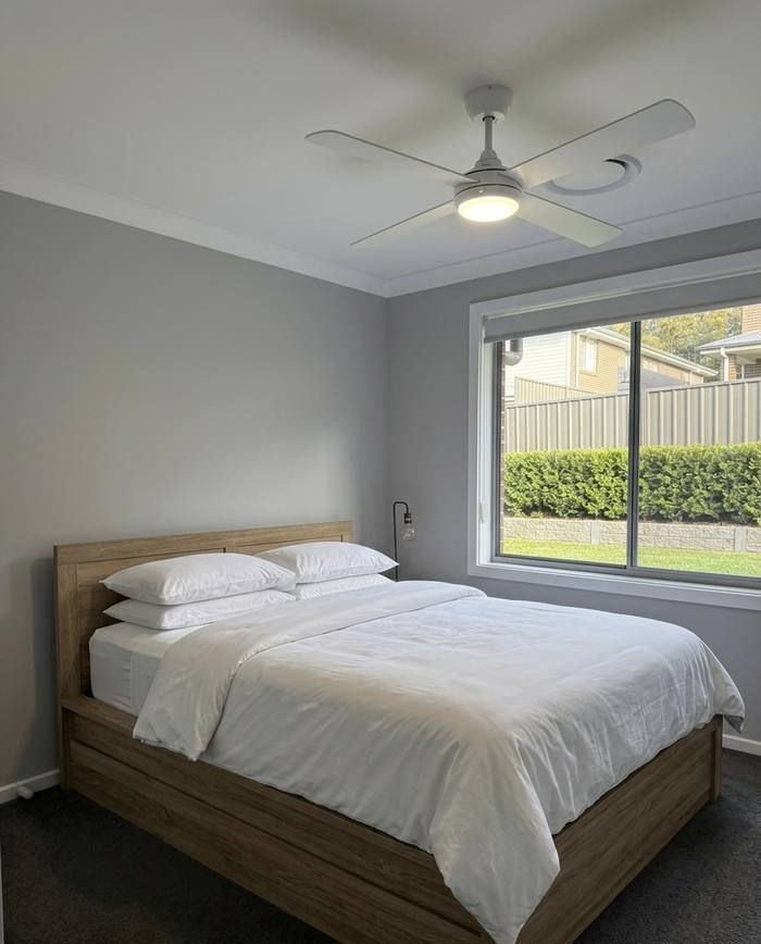 White ceiling fan with light in a bedroom